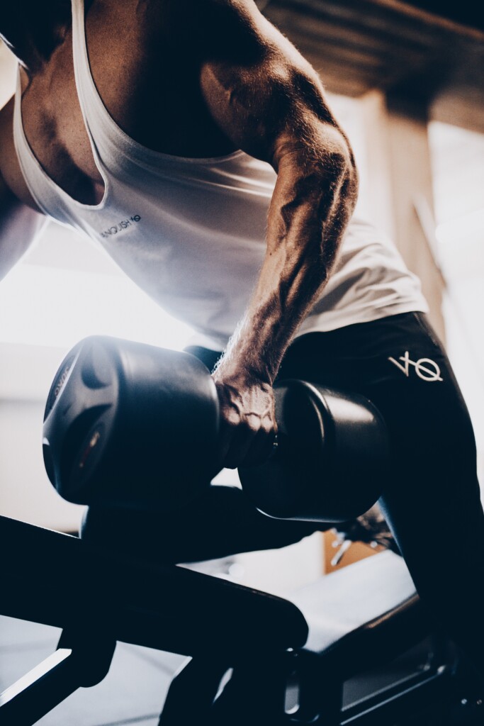 man lifting weights a man working out showing the benefits of testosterone replacement therapy