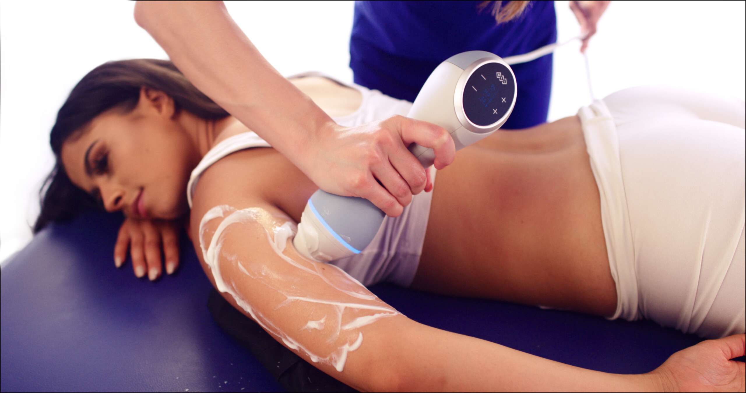 Emtone treatment being done on the back of a females arm