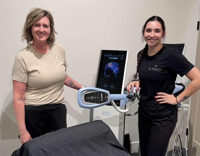 Melynda and Brianna standing with exomind machine