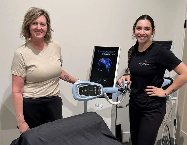 Melynda and Brianna standing with exomind machine